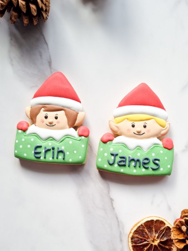 Two festive biscuit elves in red and green (1) Two festive biscuit elves in red and green